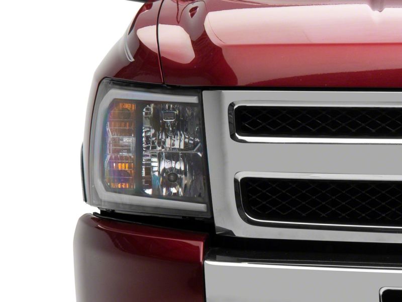 Raxiom 07-13 Chevrolet Silverado 1500 Axial Headlights w/ SEQL LED Bar- Black Housing (Clear Lens)